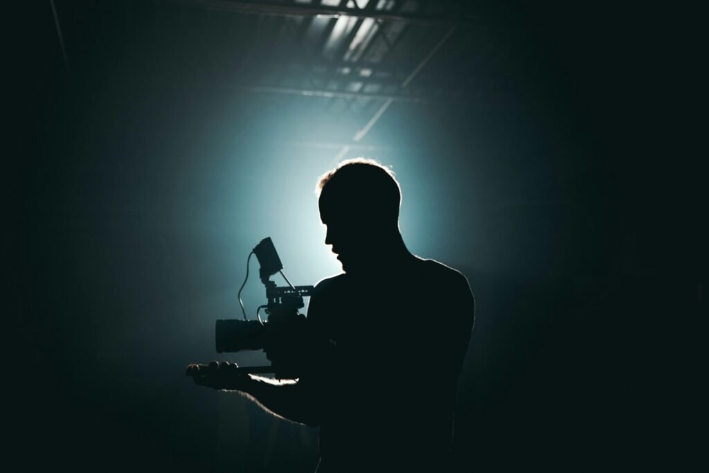 Entertainment Law Case Studies – The Vault Lab” “Silhouette of a cinematographer representing entertainment law, intellectual property issues in filmmaking, and creative industry legal analysis.”
